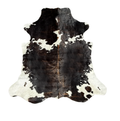 Black and white cowhide rug on a white background